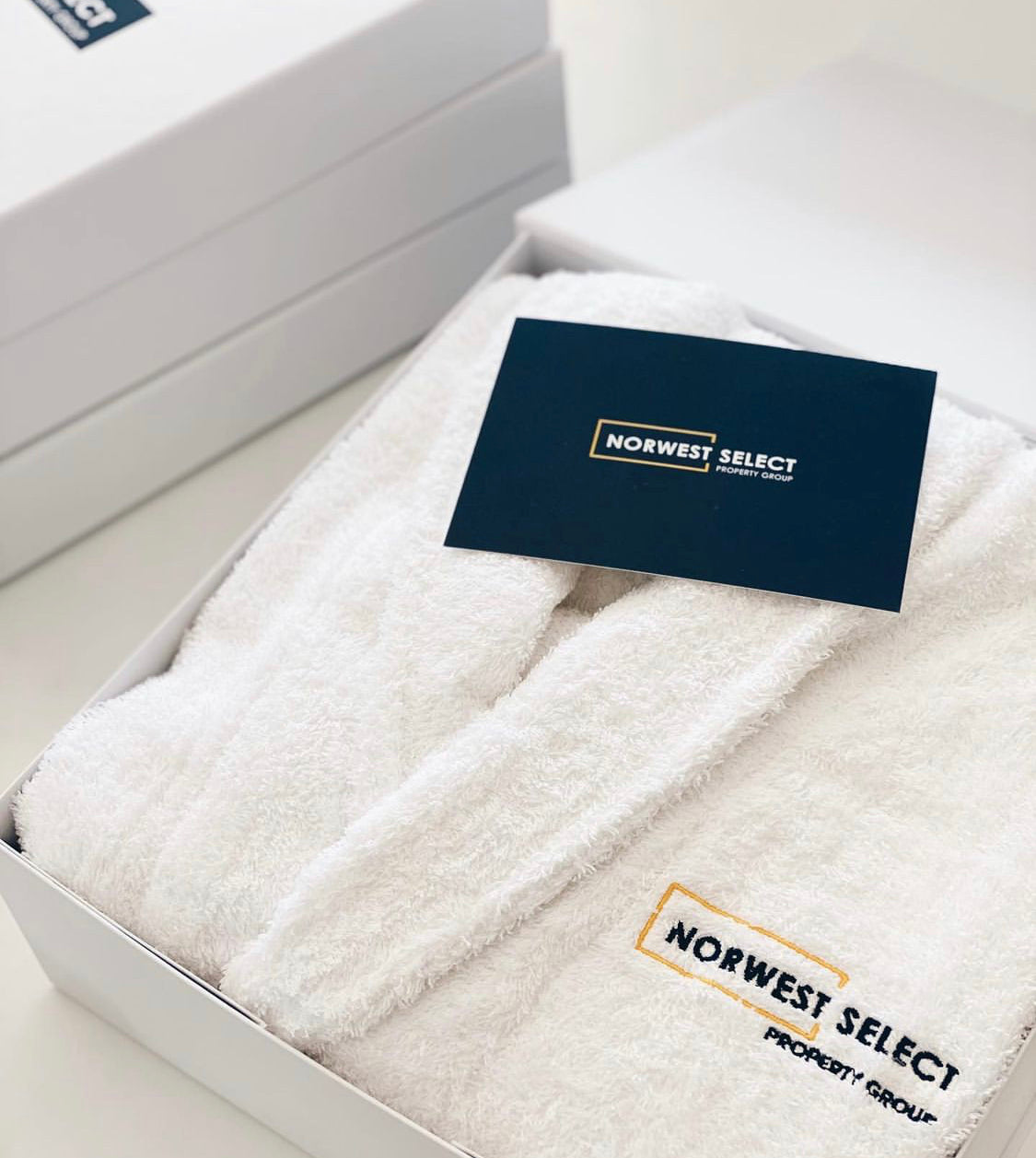 Parcelle | Norwest Select Property Group branded luxury terry towel robes for Handover day of completed construction apartment building | Embroidery services and Real Estate merchandise