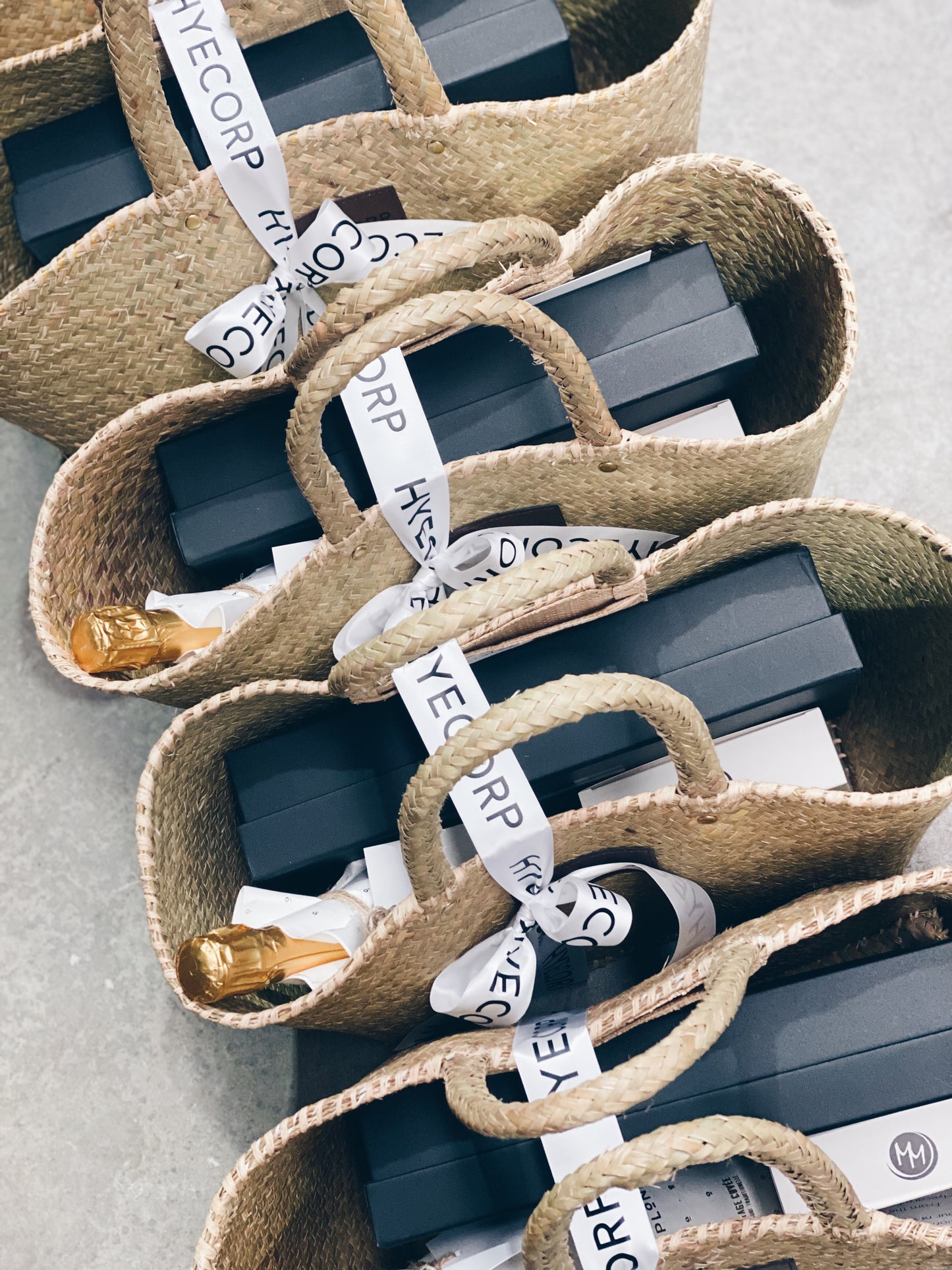 Parcelle | Custom designed gifts for completed construction property matching property location, presented in handmade raffia beach tote, Posh Plonk Cuvee and branded champagne glass set giftboxed for Hyecorp