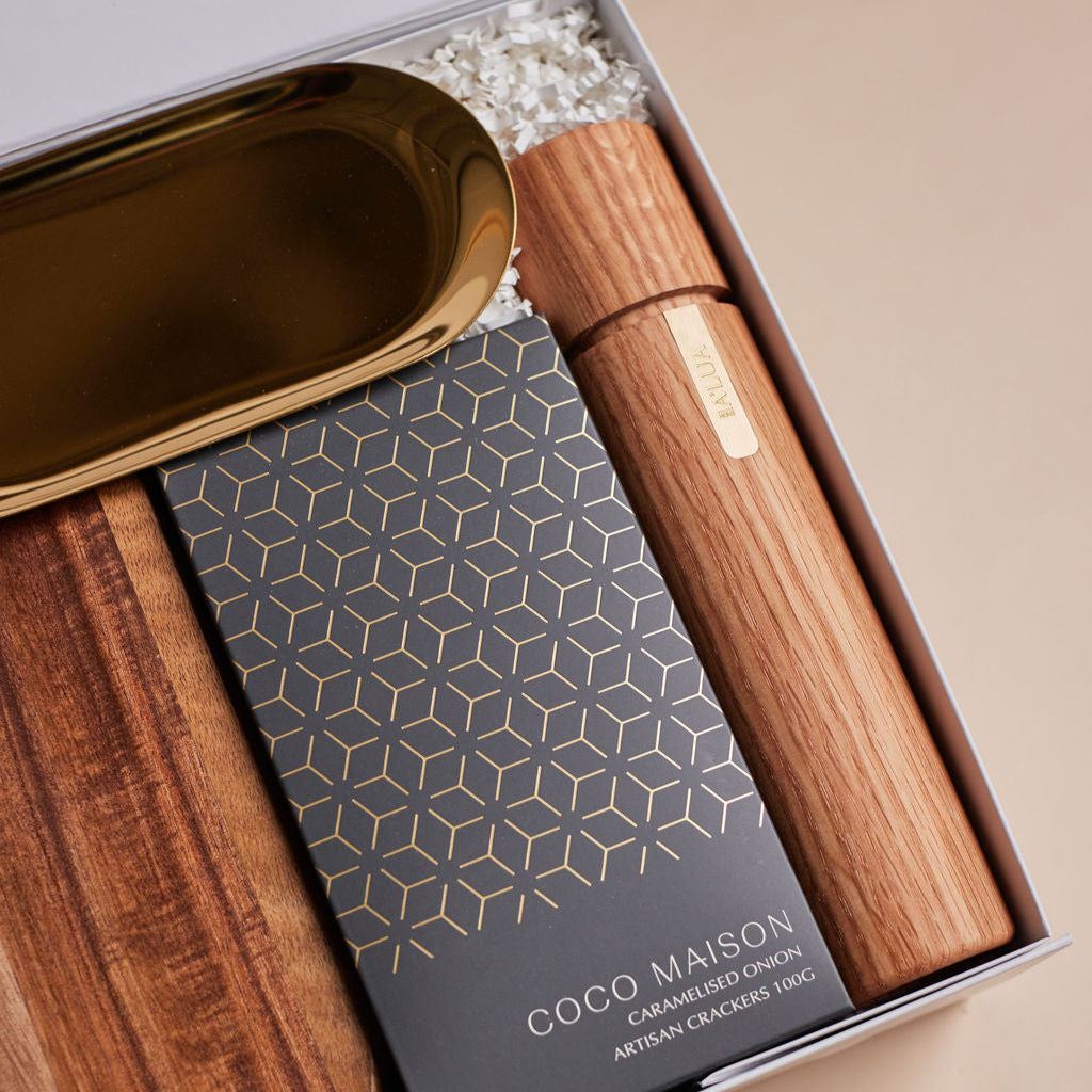 Parcelle | The Condo real estate settlement hamper with olive oil, artisan crackers, wooden salt & pepper grinder, and gold trinket dish in Parcelle gift box