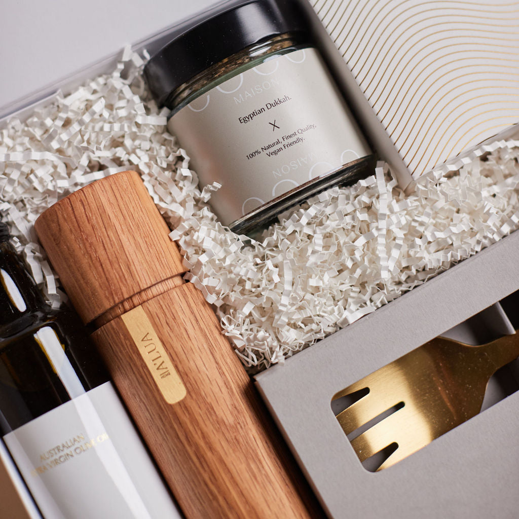 Parcelle | The Kitchenette real estate settlement hamper with olive oil, artisan crackers, wooden grinder, and gold trinket dish in Parcelle signature gift box