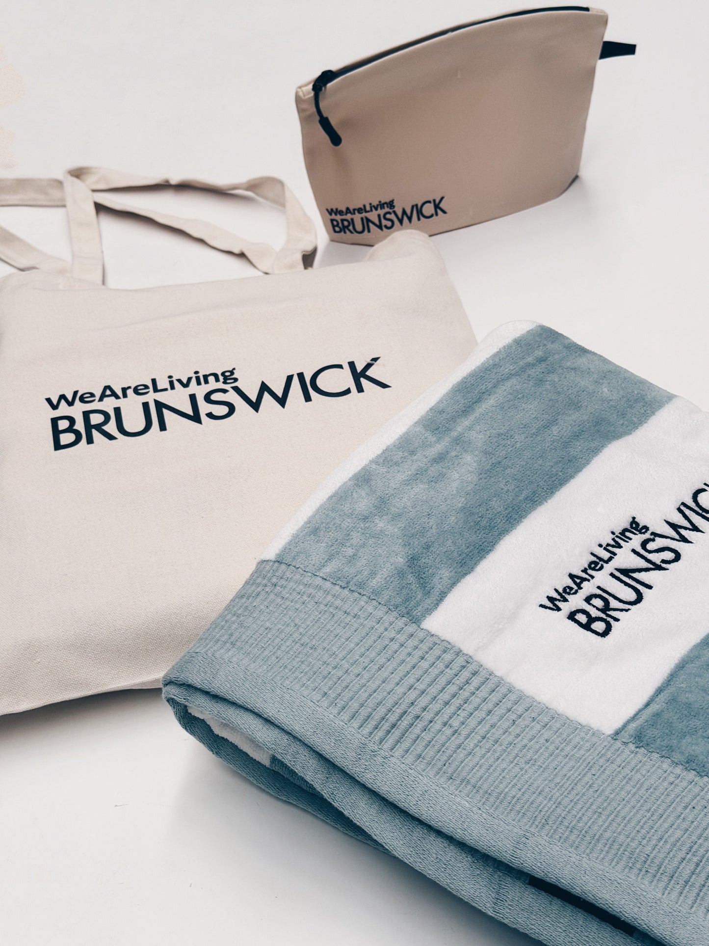 WeAreLiving Brunswick branded tote bag, poolside towel and wet bag | welcome gifts by Parcelle