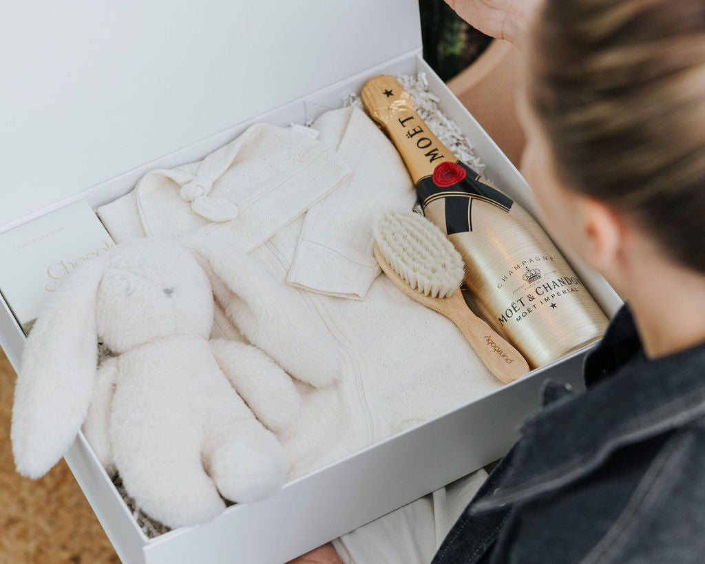 Parcelle corporate baby gift being presented — branded newborn hamper for staff and client gifting Australia