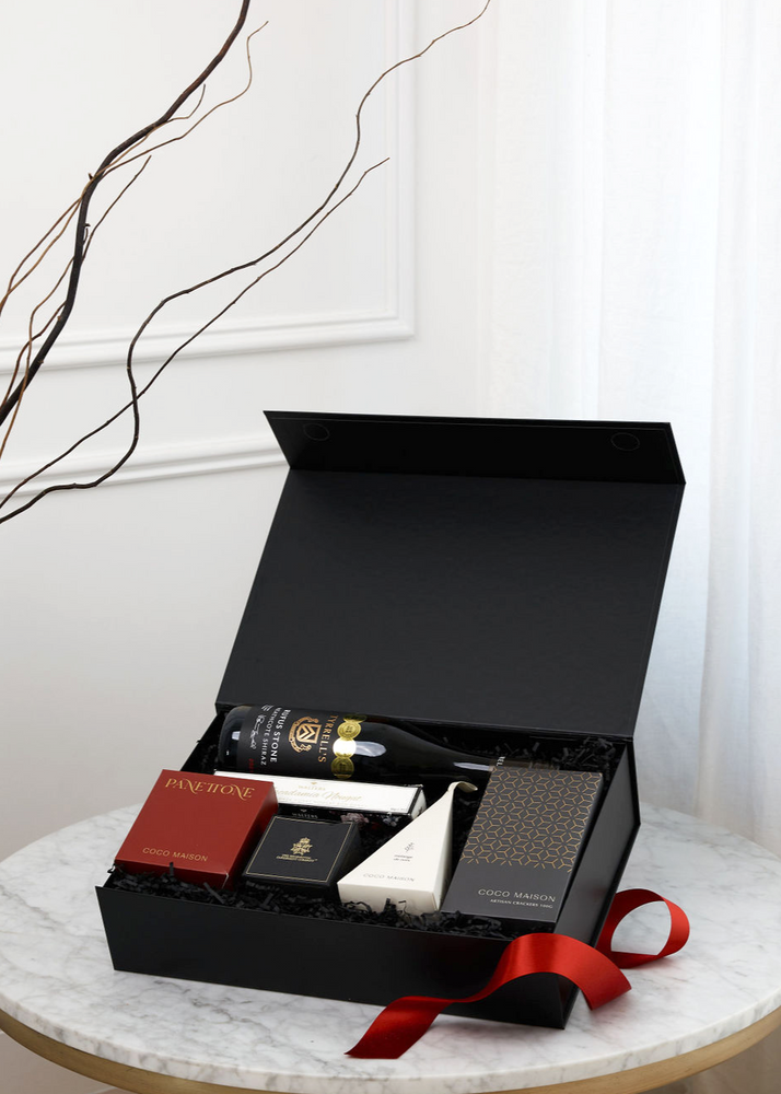 
                      
                        Parcelle | A Season's Greetings gift box featuring Tyrells Rufus Stone Heathcote Shiraz, traditional Panettone, caramelised onion crackers, and BBQ spice cashew nuts, elegantly presented in a Parcelle White or Black Luxury Large Giftbox for Christmas gifting
                      
                    