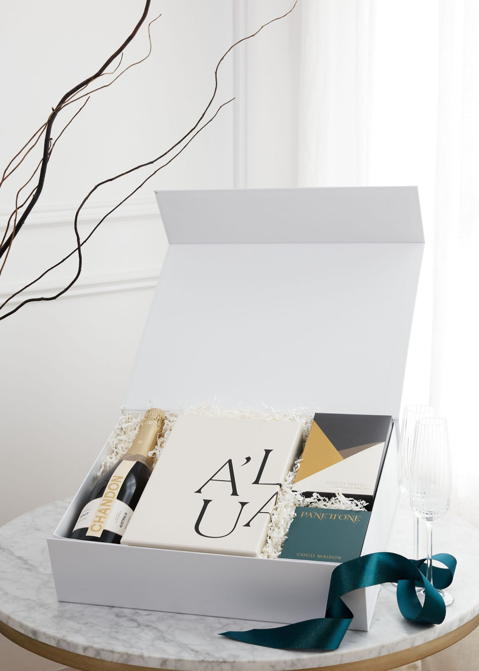 A Sparkling Christmas luxury hamper with Chandon Sparkling, Chocolate Chip Panettone, Chocolate Trio, and Premium Fluted Champagne Glasses, presented in Parcelle XL Gift Box with Australiana or Candy Stripe sleeve, free branding available.