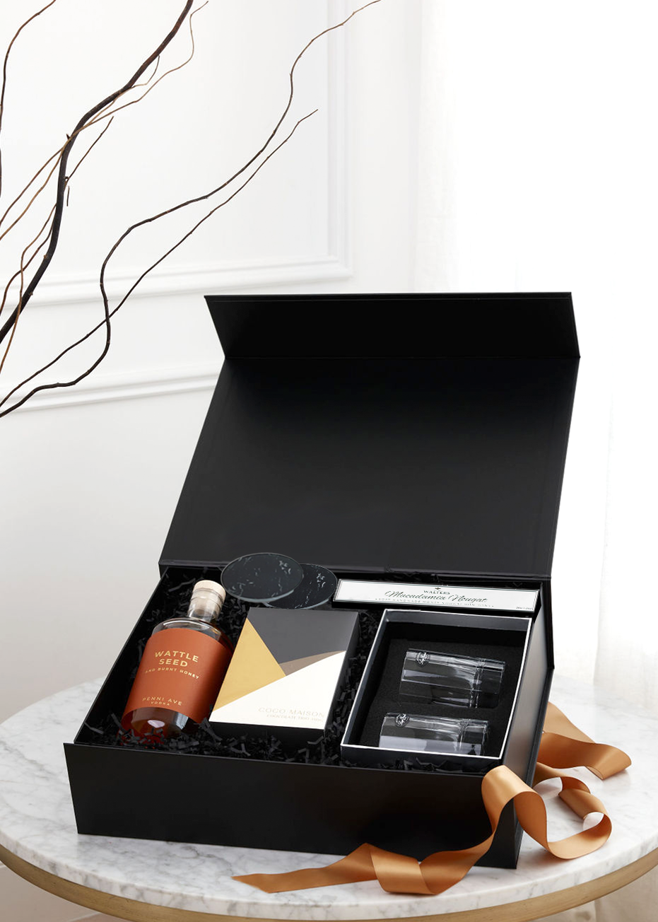 Parcelle | Open "Spirits are Bright" gift box showcasing Penni Ave Wattle Seed & Burnt Honey Vodka and Coco Maison Deluxe Chocolate Trio by Parcelle