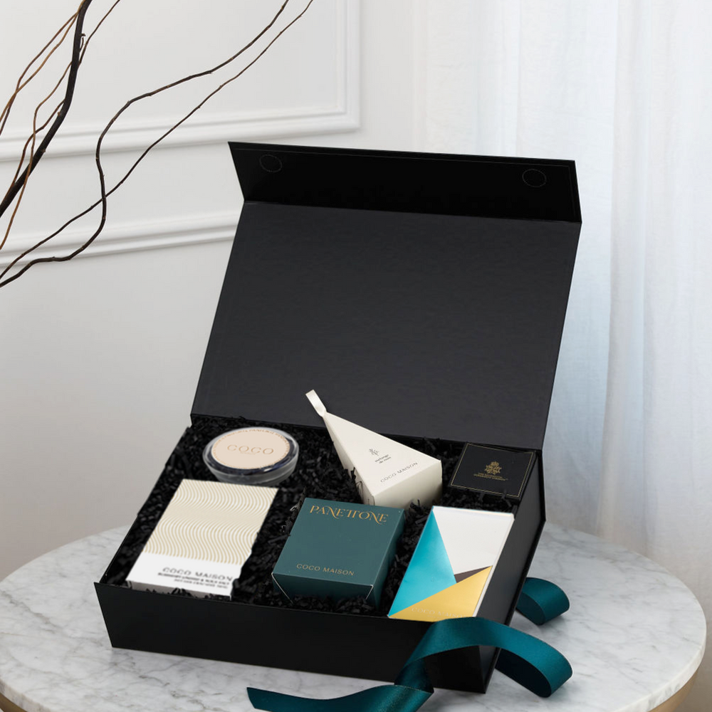 Parcelle | Christmas Bites luxury hamper with Choc Chip Panettone, Pistachio Knafeh Chocolate Bar, BBQ Cashews, Rosemary Crackers, Tapenade, and Panforte, presented in Parcelle gift box with Australiana or Candy Stripe sleeve, free branding available