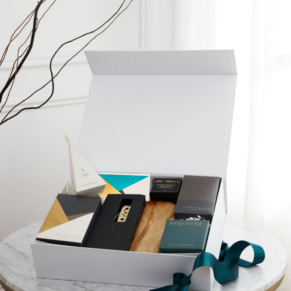 Parcelle | Deck the Halls Christmas hamper with cheese board, gold cheese knife set, Panettone, Pistachio Knafeh chocolate, crackers & savoury treats in Parcelle XL gift box.