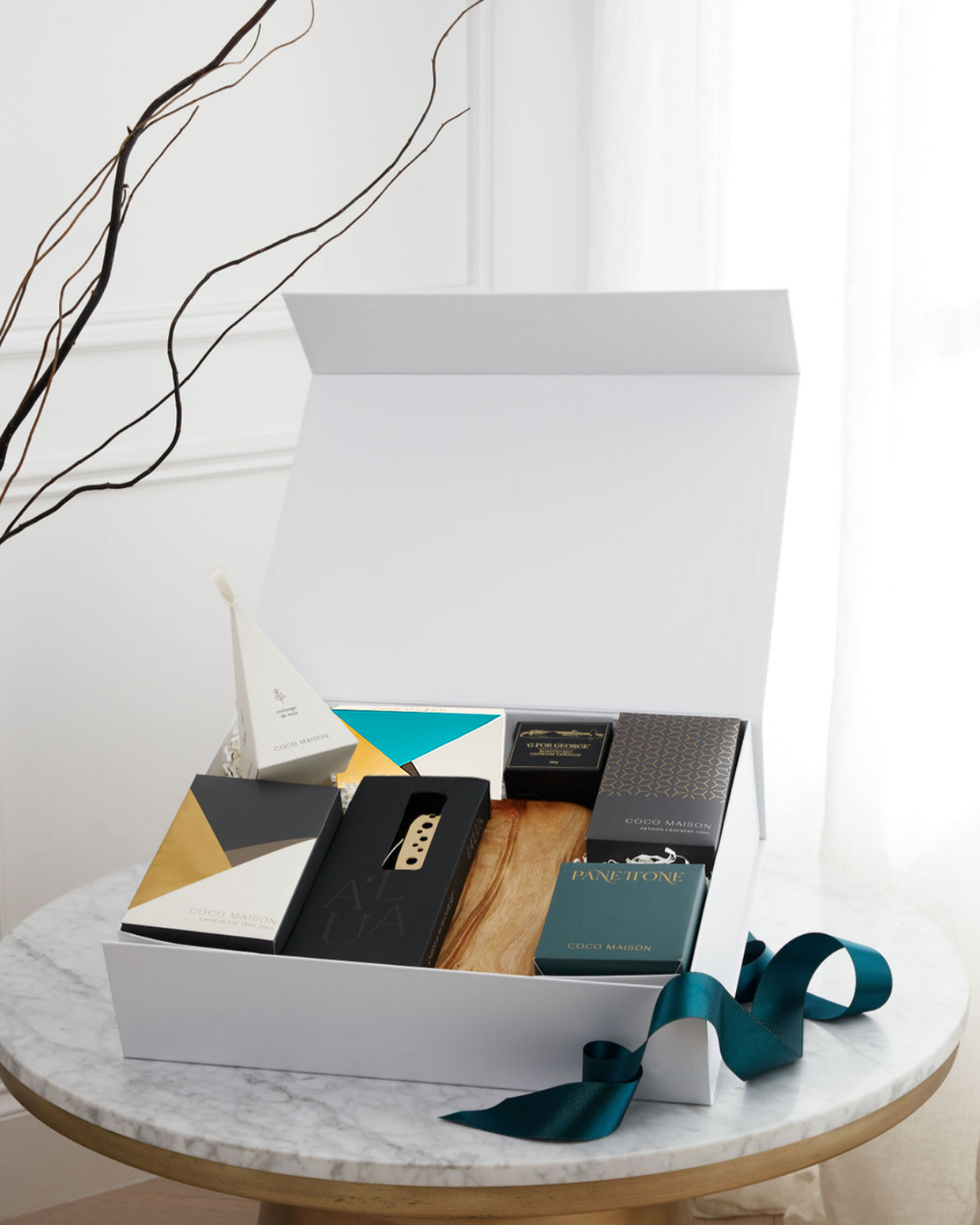 Parcelle | Deck the Halls Christmas hamper with cheese board, gold cheese knife set, Panettone, Pistachio Knafeh chocolate, crackers & savoury treats in Parcelle XL gift box.