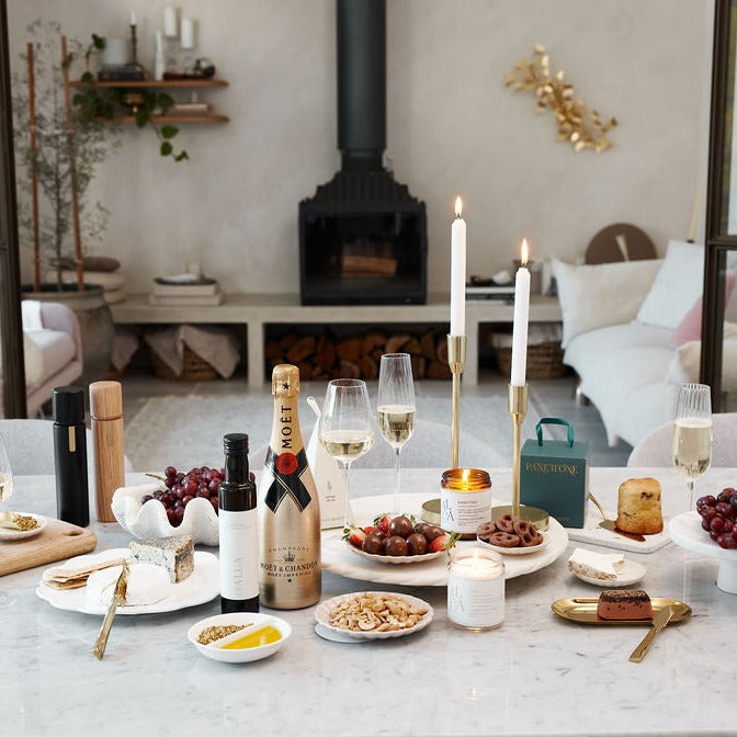 Parcelle | Corporate Christmas gift box items displayed on a beautifully decorated table, highlighting Parcelle's premium hampers ideal for client and staff gifting