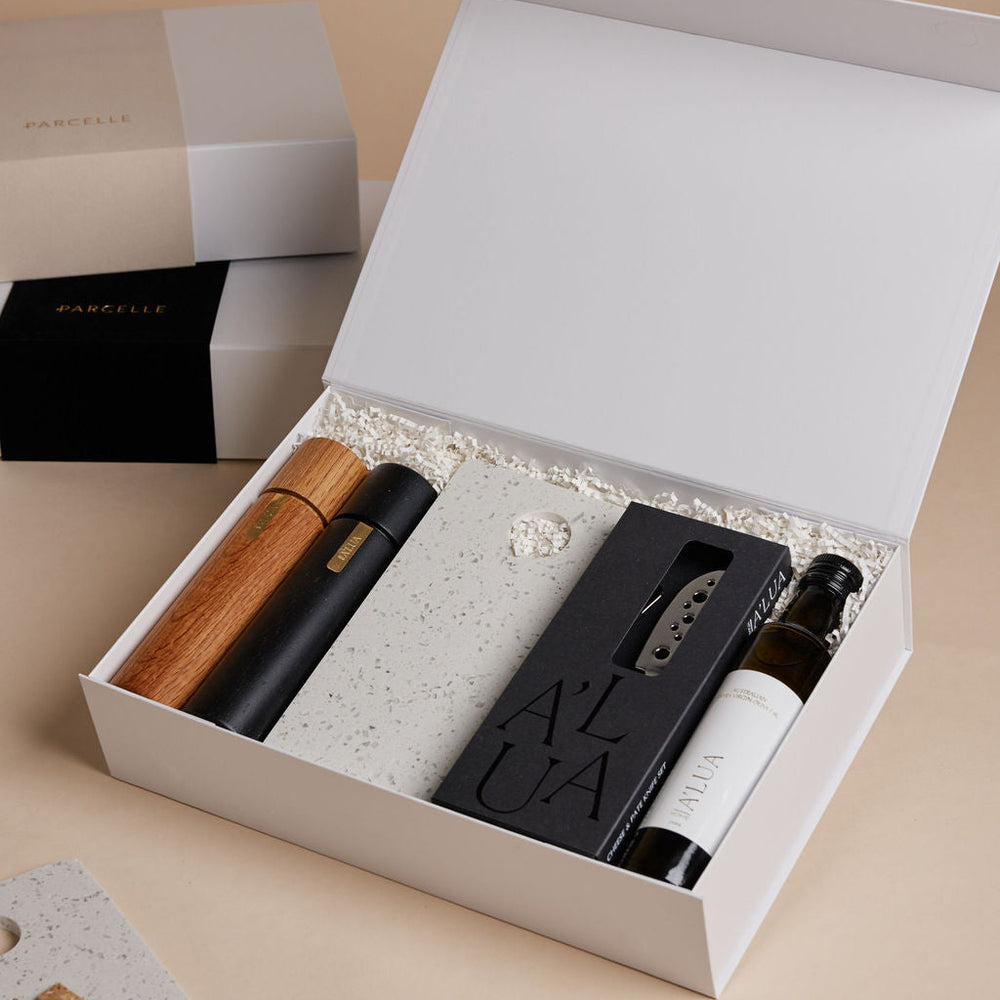 Parcelle | The Terrace luxury property settlement hamper with olive oil, terrazzo stone serving board, wooden grinders, and cheese knife set in Parcelle gift box