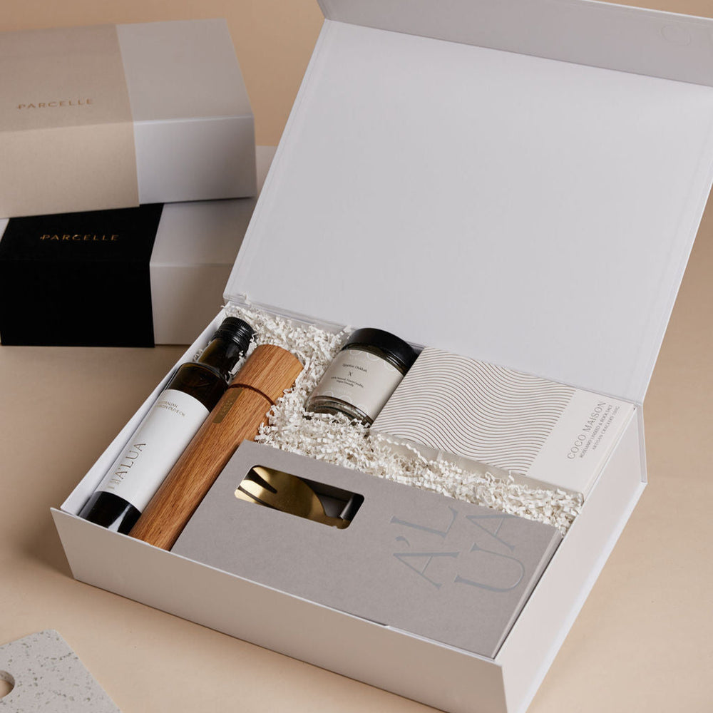 Parcelle | The Kitchenette real estate settlement hamper with olive oil, artisan crackers, wooden grinder, and gold trinket dish in Parcelle signature gift box
