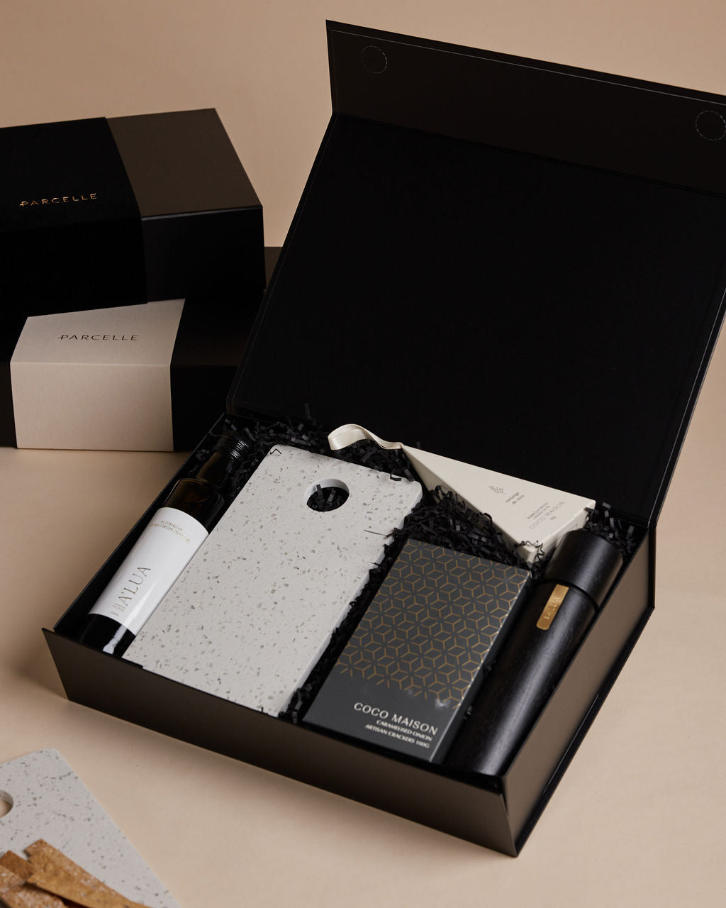 Parcelle | The Studio settlement hamper with olive oil, artisan crackers, terrazzo board, BBQ cashews, and black wooden grinder — corporate housewarming gift Sydney