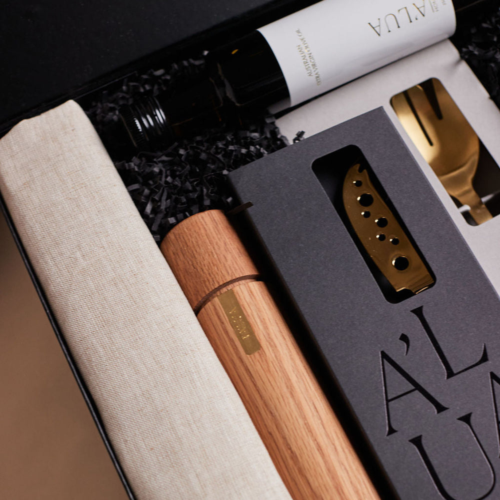 Parcelle | Close-up of The Entertainer hamper with artisan homewares and gourmet essentials