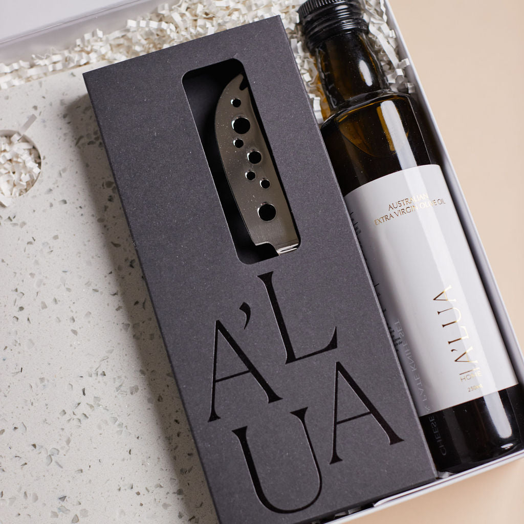 Parcelle | The Terrace luxury property settlement hamper with olive oil, terrazzo stone serving board, wooden grinders, and cheese knife set in Parcelle gift box