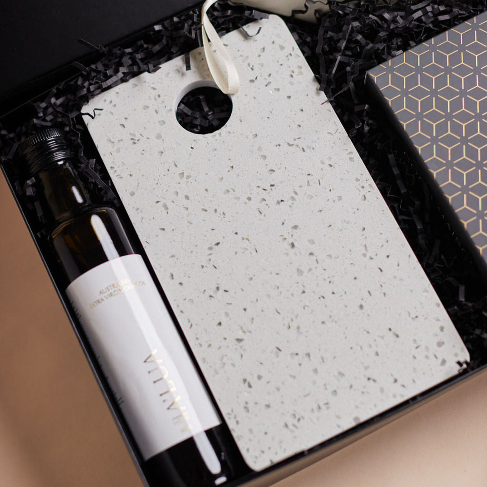 Parcelle | The Studio settlement hamper with olive oil, artisan crackers, terrazzo board, BBQ cashews, and black wooden grinder — corporate housewarming gift Sydney