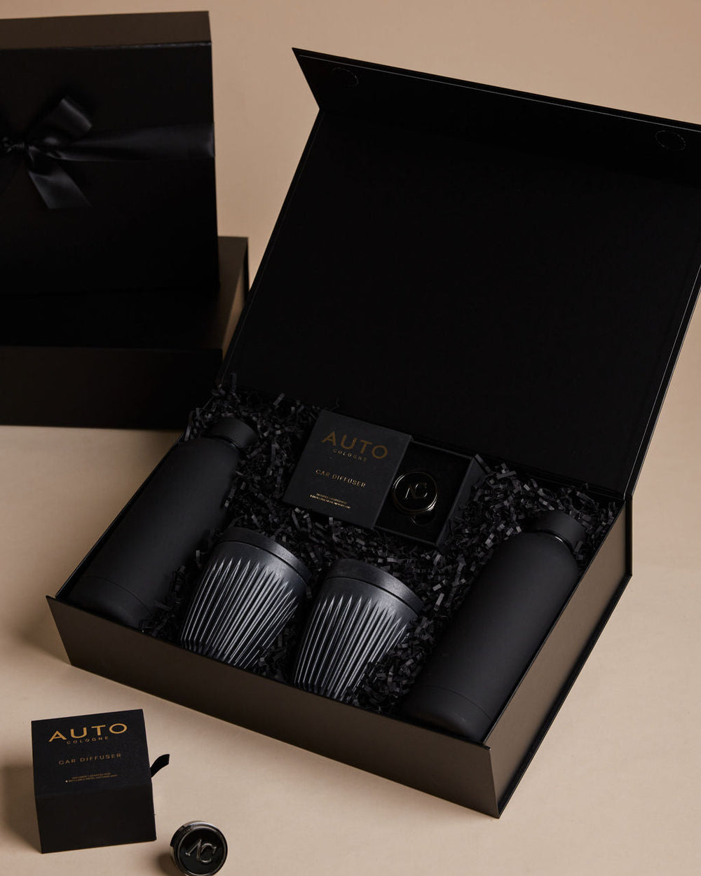 Parcelle | Windows Down gift set featuring branded water bottles, reusable coffee cups, and car fragrance in Parcelle packaging