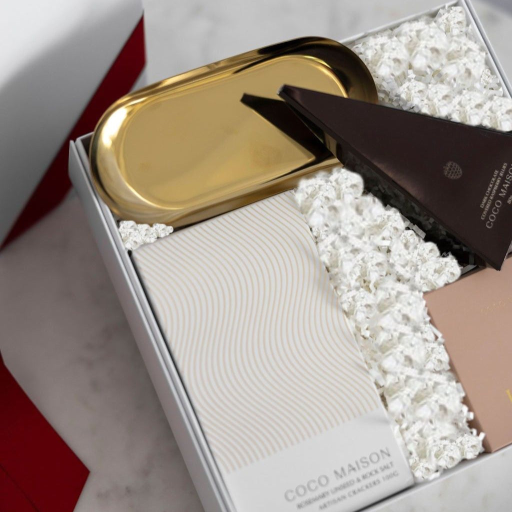 Parcelle | Inside view of Christmas Cheer hamper showing Rosemary Crackers, Milk Chocolate Honeycomb, Dark Chocolate Raspberries, and Gold Dish, elegantly packed in Parcelle Signature Gift Box with festive sleeve