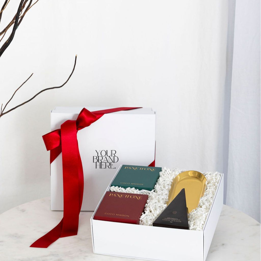 Parcelle_Classic Christmas corporate hamper with Panettone, Raspberry Jellies, and Gold Tray, presented in Parcelle gift box with Australiana or Candy Stripe sleeve, free branding available