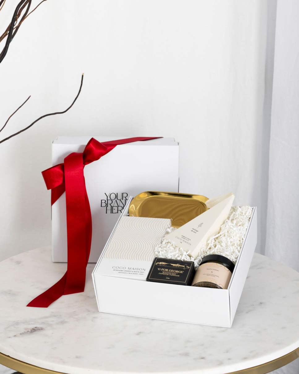 Parcelle | Christmas Snowy Delights hamper with Rosemary & Sea Salt Crackers, Tapenade, Cashews, Dukkah, and Gold Dish, presented in Parcelle Signature Gift Box with festive sleeve, free branding available