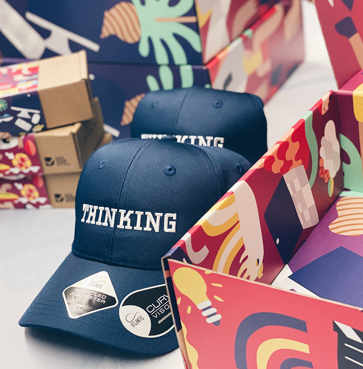 Parcelle | Custom embroidered navy hats and recycled sunglasses with branded packaging in mailer box for Christmas Staff Gifts