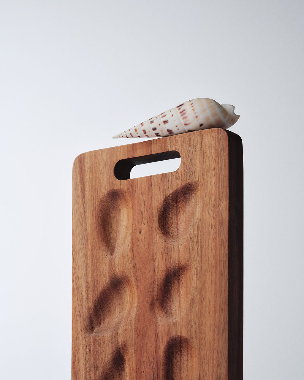 Parcelle hand-carved walnut Oysteria serving board with oyster wells, the keepsake included in this Christmas gift