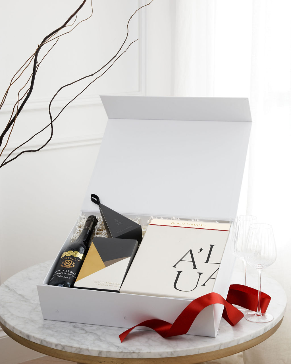 Parcelle | Shiraz Celebration luxury Christmas hamper with Rufus Stone Shiraz, Chocolate Trio, Biscoff Chocolate, Macadamias, and Premium Fluted Wine Glasses, presented in Parcelle XL Gift Box with Australiana or Candy Stripe sleeve, free branding available